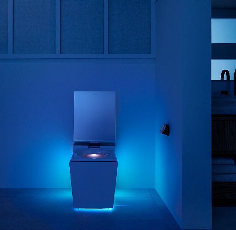 Kohler Numi 2.0 toilet in dark bathroom with lights on and seat open | Kohler smart toilet | Weinstein Bath & Kitchen Showroom Collegeville