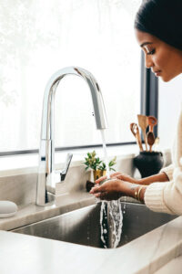 Woman washing hands with Moen Plus Smart Faucet | Moen Plus Smart Faucets | Weinstein Collegeville
